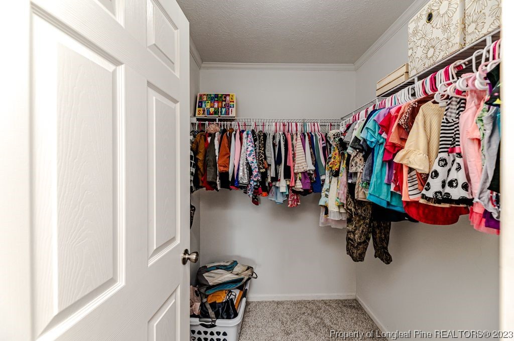 125 Wright Road Vass, NC 28394 - Photo 38 of 48 a view of walk in closet with clothes and shoes