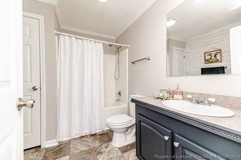 125 Wright Road Vass, NC 28394 - Photo 39 of 48 a bathroom with a granite countertop sink a toilet and a shower