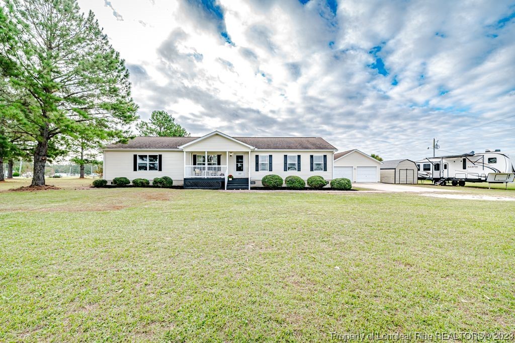 125 Wright Road Vass, NC 28394 - Photo 4 of 48 a front view of house with yard and lake view