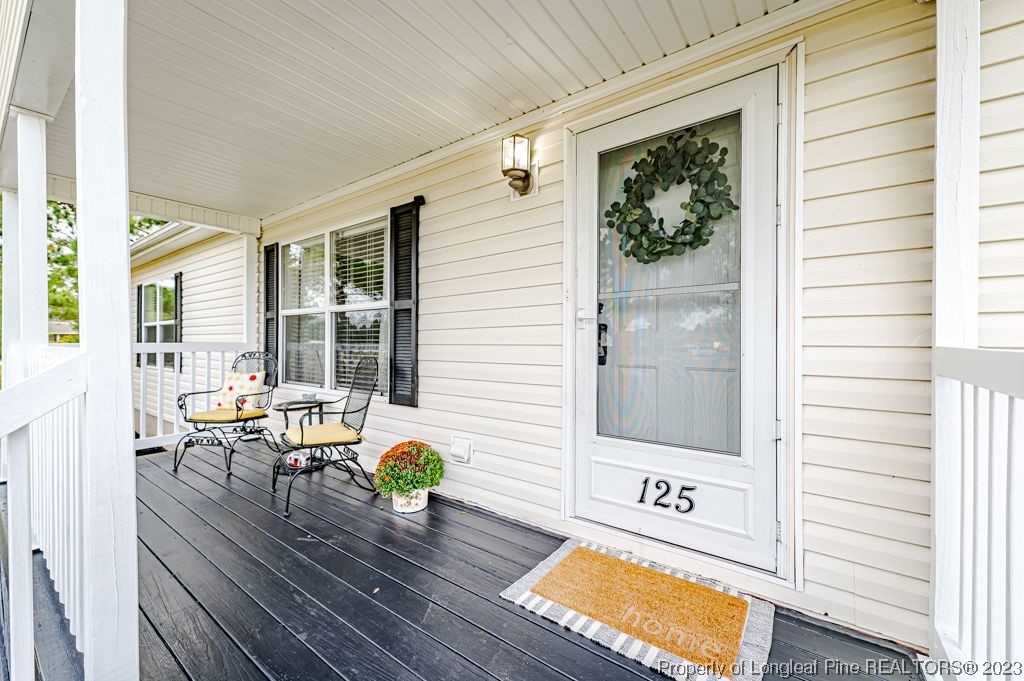 125 Wright Road Vass, NC 28394 - Photo 5 of 48 a view of a patio with table and chairs and wooden floor