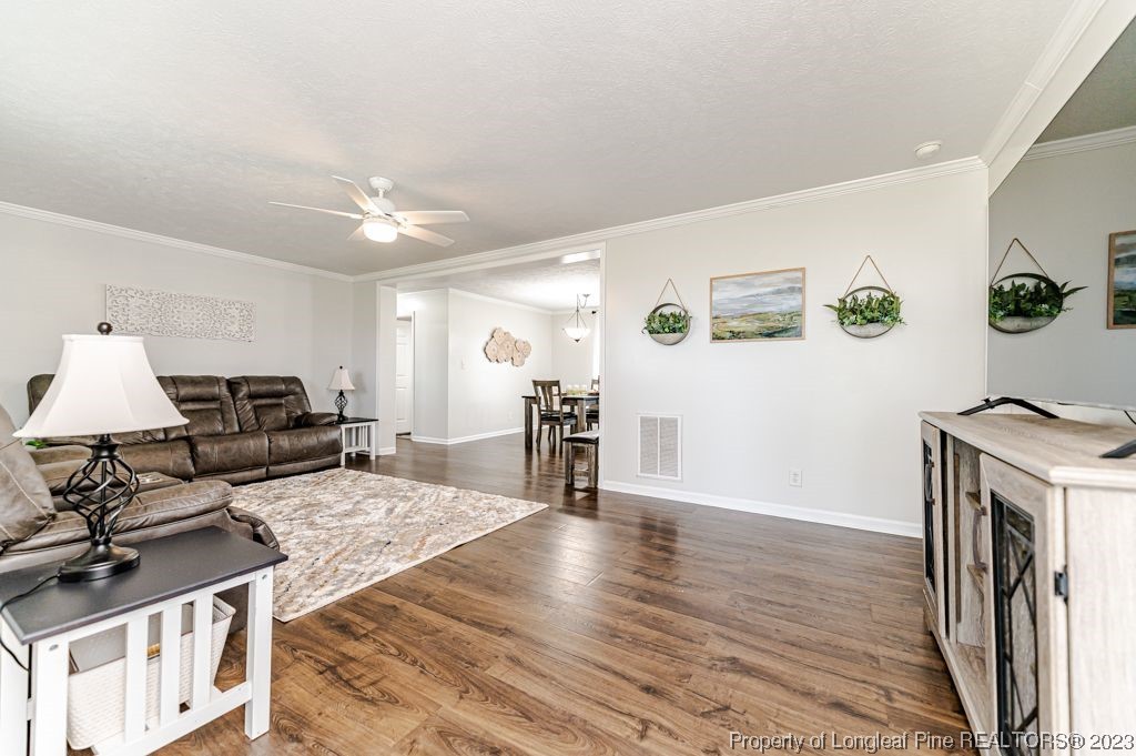 125 Wright Road Vass, NC 28394 - Photo 7 of 48 a living room with furniture and a flat screen tv