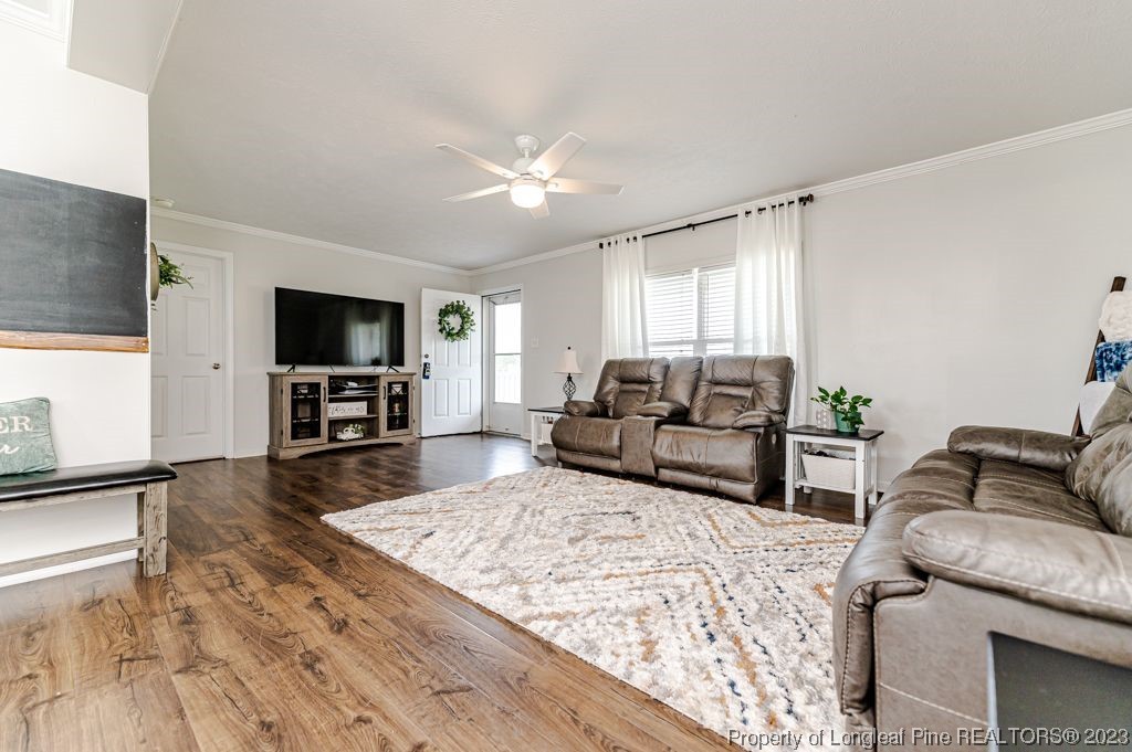 125 Wright Road Vass, NC 28394 - Photo 8 of 48 a living room with furniture and a flat screen tv