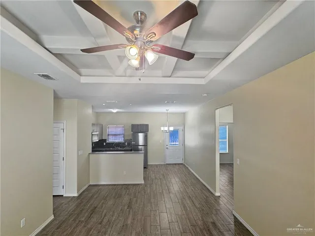 a view of a kitchen with a refrigerator a microwave oven a sink and dishwasher