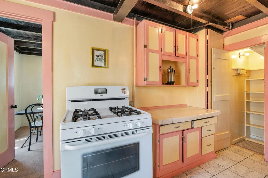 2122 Navarro Avenue Altadena, CA 91001 - Photo 24 of 40 a kitchen with granite countertop cabinets and white appliances