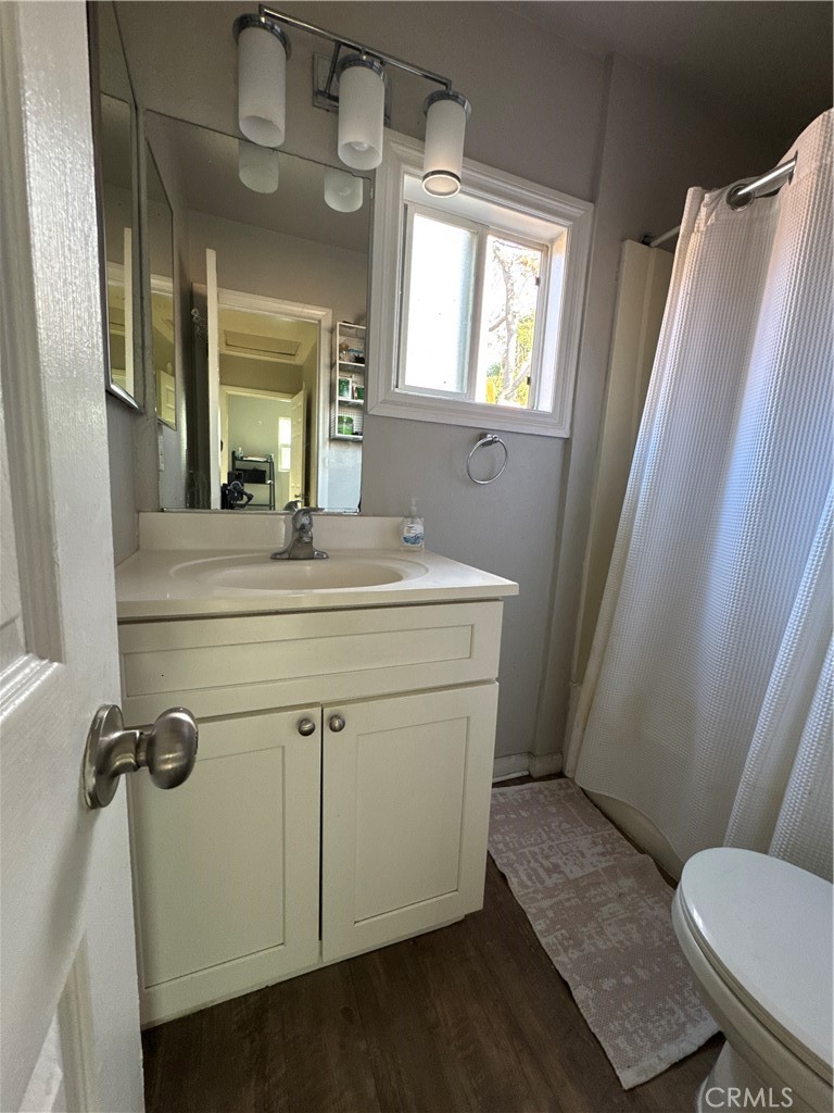 4438 Park Avenue Riverside, CA 92507 - Photo 19 of 23 a bathroom with a sink a toilet a mirror and window