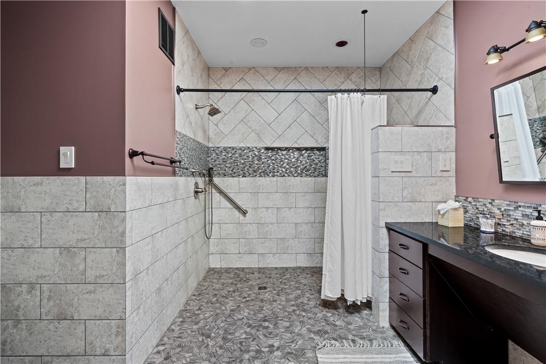 1506 Pleasant View Road Coopersburg, PA 18036 - Photo 56 of 97 The bathroom features a custom-tiled walk-in shower with mosaic accents and a sophisticated vanity.