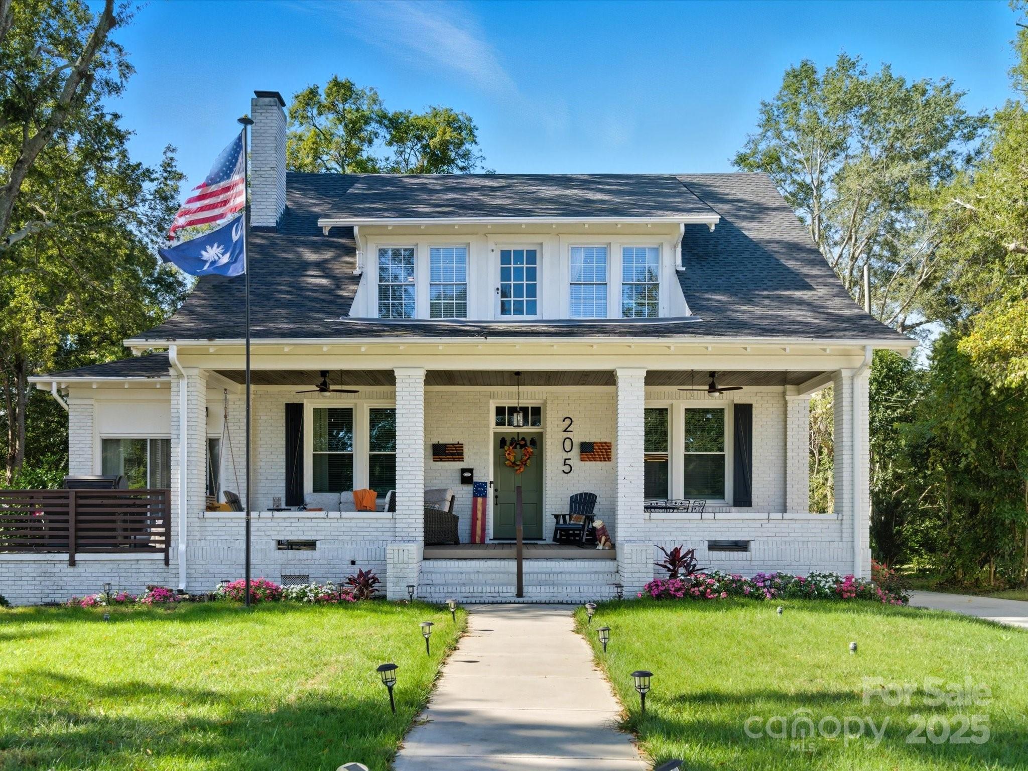 a view of house with yard and front view of a house