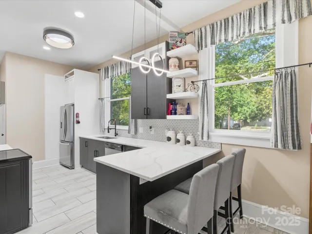 a dining table with chairs and window