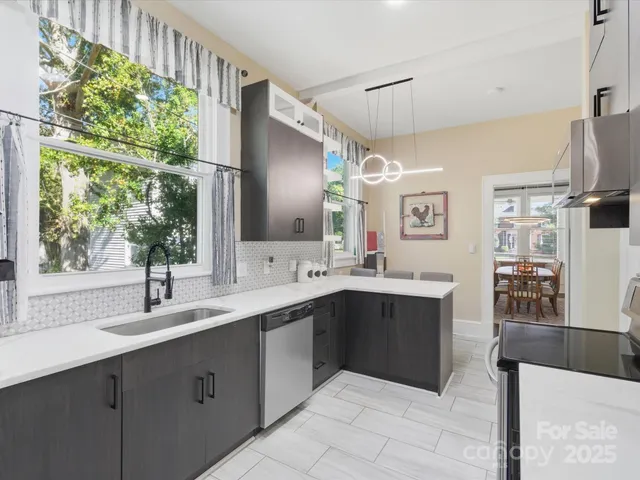 a kitchen with stainless steel appliances a sink stove and cabinets
