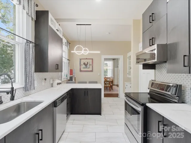 a kitchen with stainless steel appliances granite countertop a sink and stove