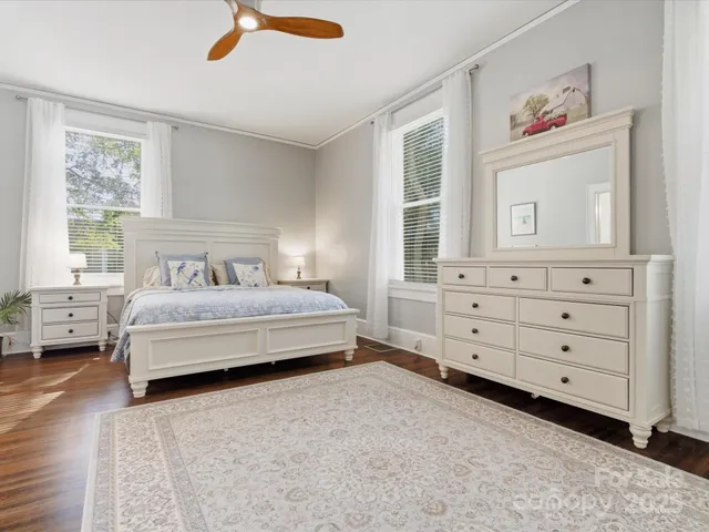 a bedroom with a large bed and a chandelier
