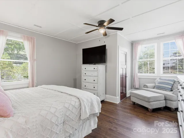 a bedroom with a bed and a painting on the wall