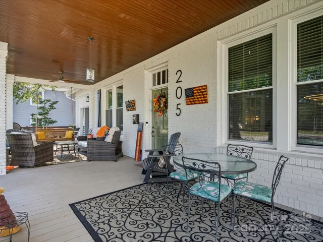 a backyard of a house with barbeque oven table and chairs