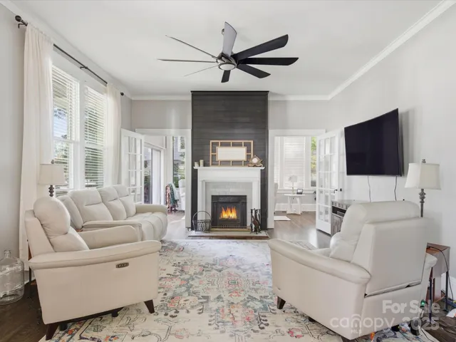 a living room with furniture a fireplace and a flat screen tv