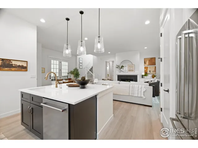 a kitchen with kitchen island a sink stove and white cabinets