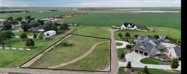 an aerial view of a house with a garden and lake view