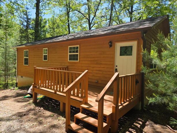 a view of a house with a wooden deck