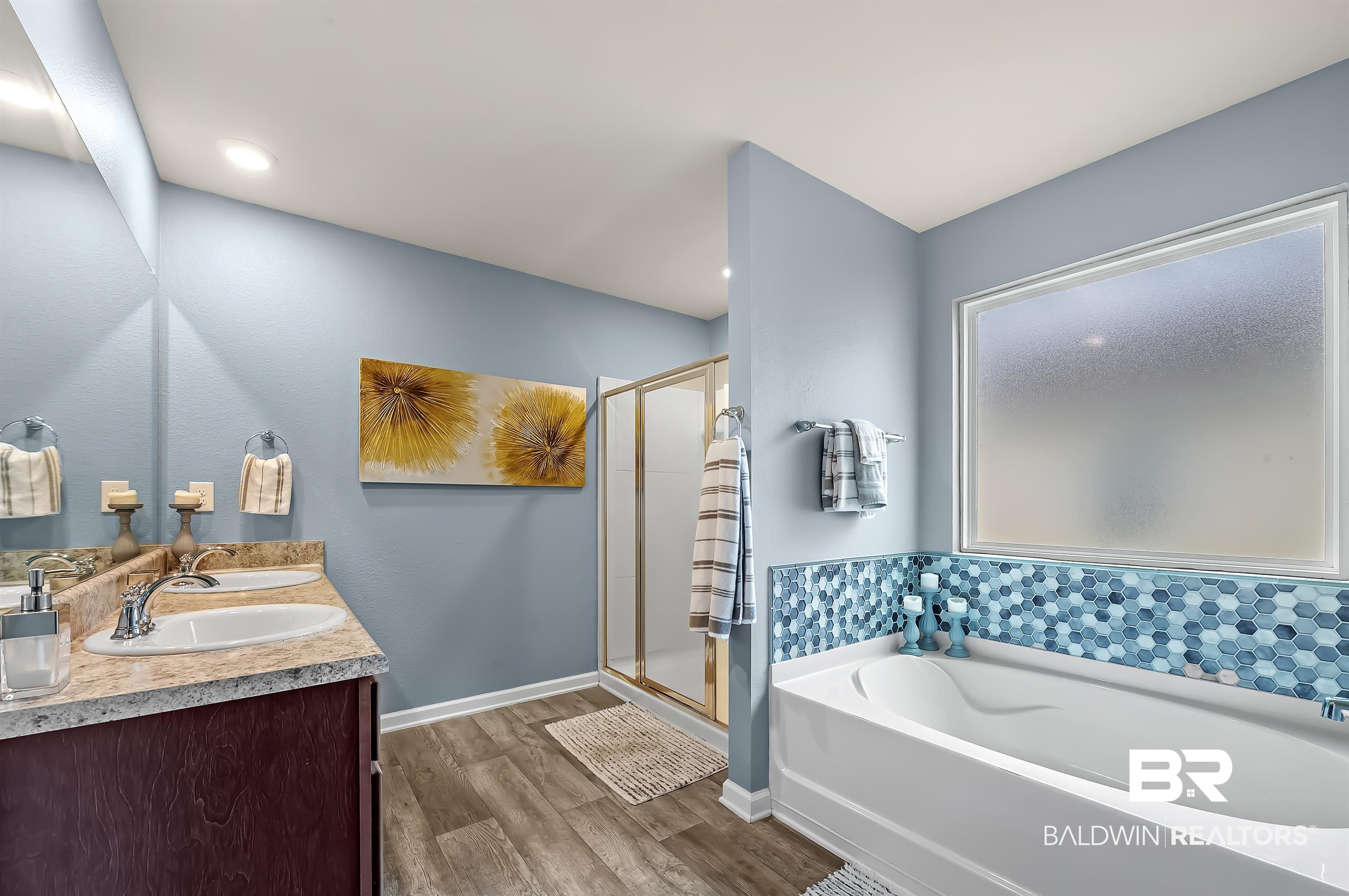 17985 Lewis Smith Drive Foley, AL 36535 - Photo 29 of 56 Bathroom with plus walk in shower, hardwood / wood-style flooring, and vanity