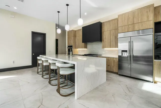 a bedroom with a large bed and a large window