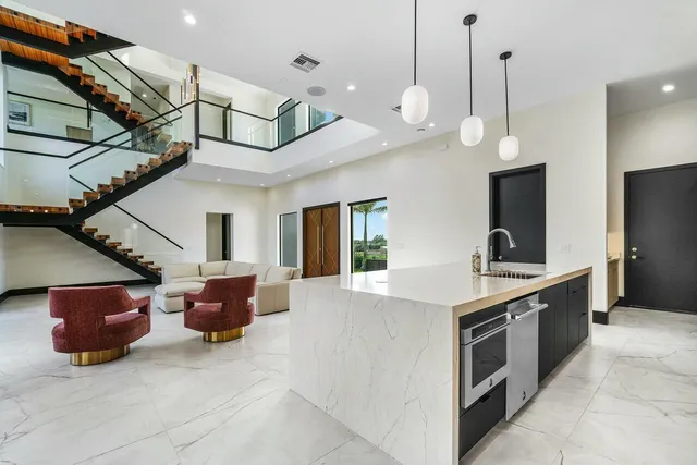 a en suite bathroom with a granite countertop double vanity and a large mirror