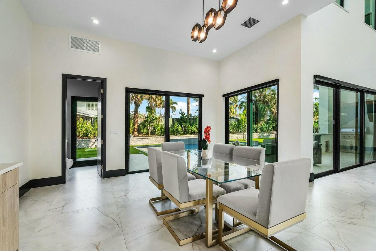 13480 Highway 1 Juno Beach, FL 33408 - Photo 16 of 90 a dining room with furniture and a floor to ceiling window