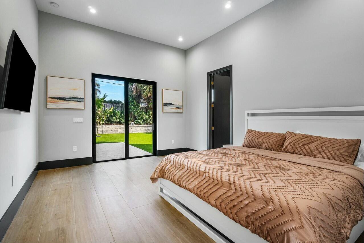 13480 Highway 1 Juno Beach, FL 33408 - Photo 38 of 90 a bedroom with a bed and a flat screen tv