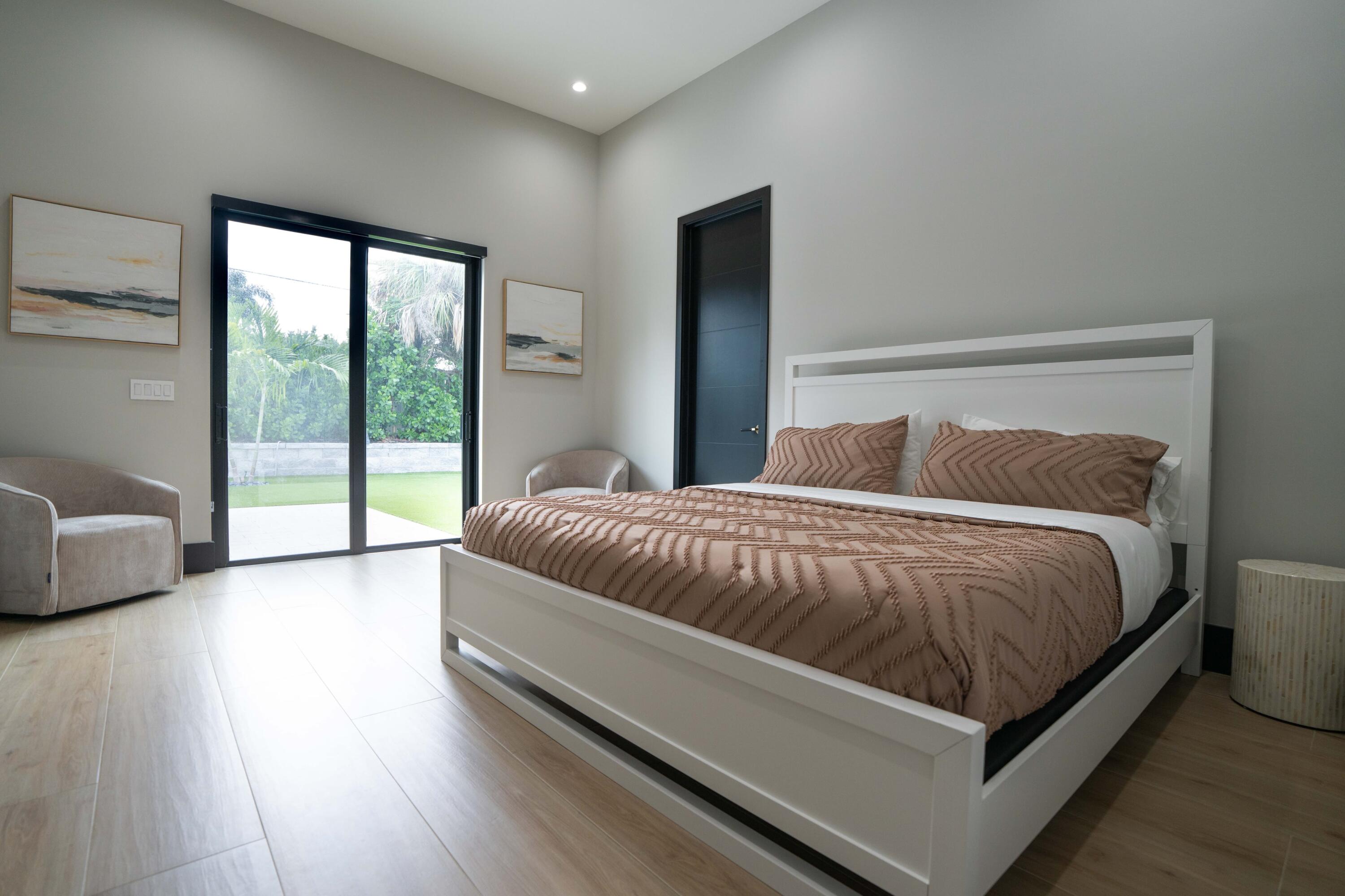 13480 Highway 1 Juno Beach, FL 33408 - Photo 39 of 90 a bedroom with a large bed and a large window