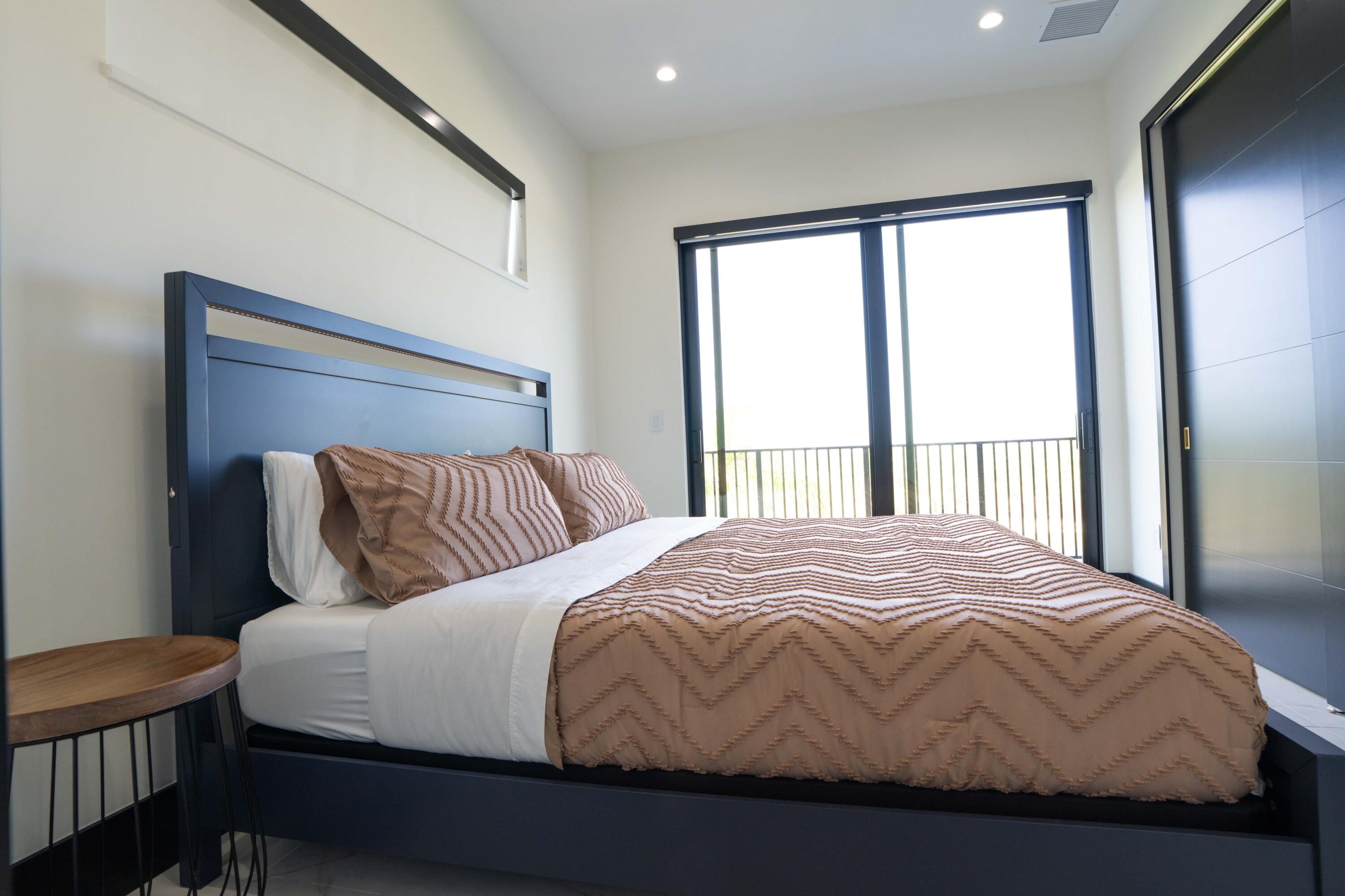 13480 Highway 1 Juno Beach, FL 33408 - Photo 43 of 90 a bedroom with a large bed and a large window