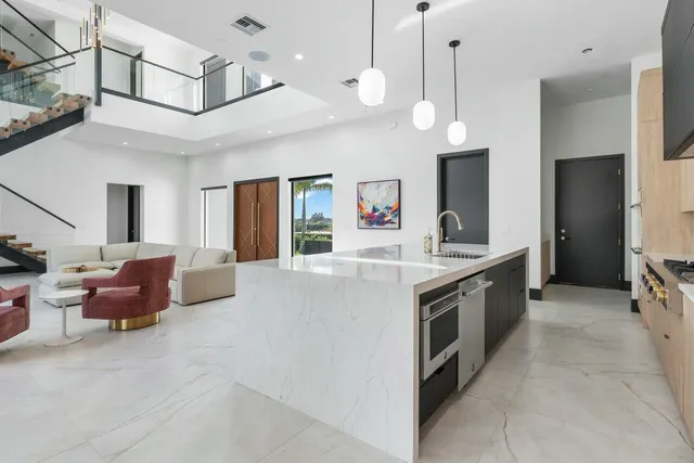 a view of a porch with chairs and floor to ceiling window