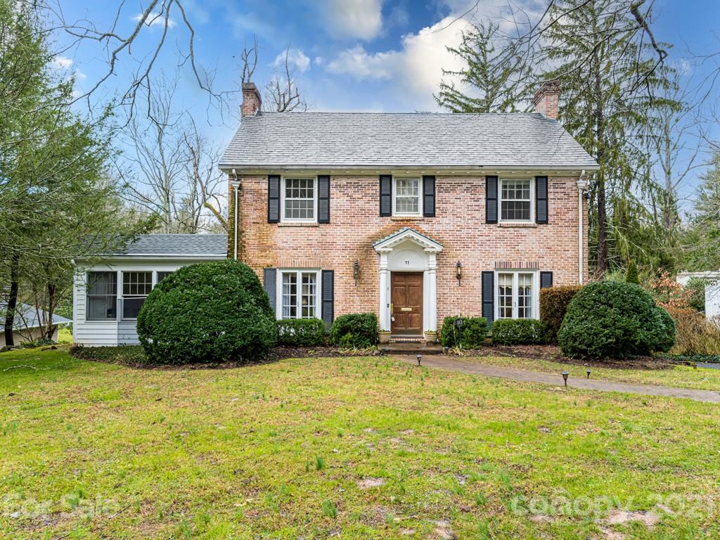 11 Hilltop Road Asheville, NC 28803 - Photo 2 of 42 a view of a white house with a yard and plants