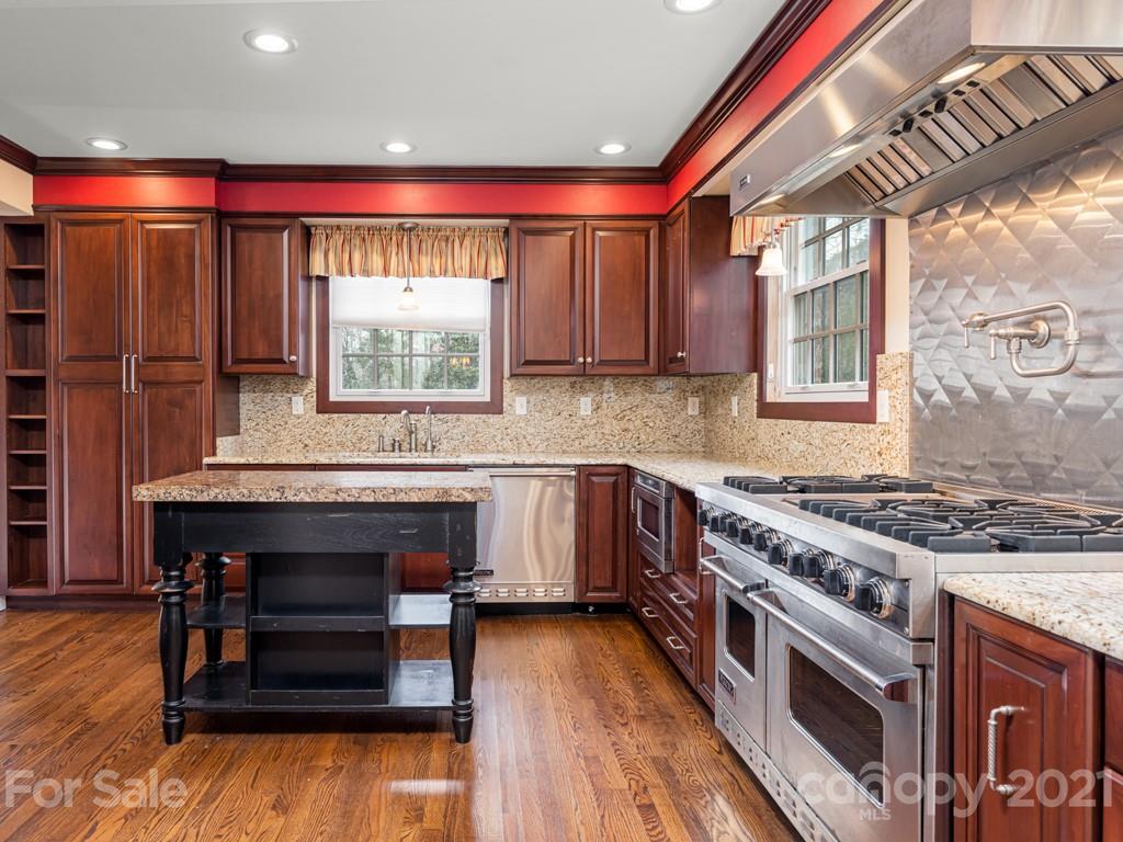 11 Hilltop Road Asheville, NC 28803 - Photo 14 of 42 a kitchen with stainless steel appliances granite countertop a stove and a sink