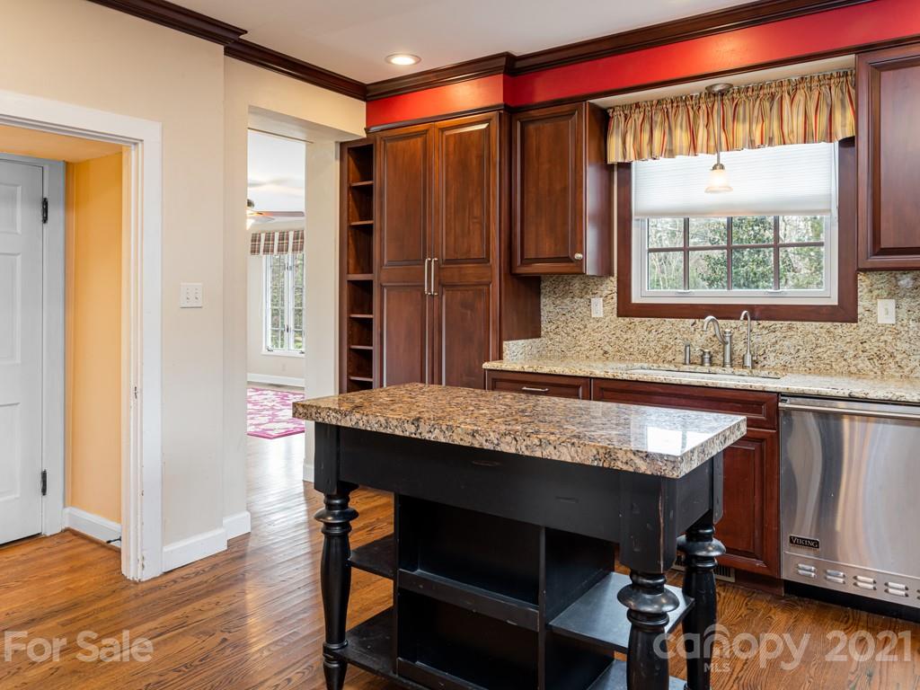 11 Hilltop Road Asheville, NC 28803 - Photo 15 of 42 a kitchen with a sink a chair and wooden floor