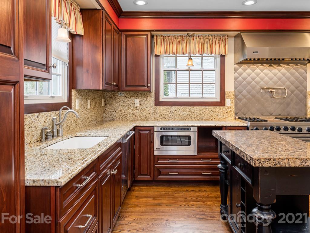 11 Hilltop Road Asheville, NC 28803 - Photo 17 of 42 a kitchen with a sink stove and cabinets