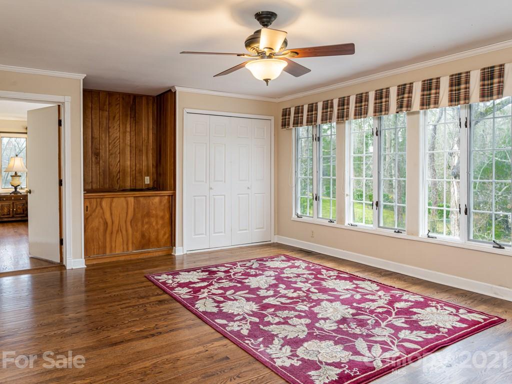 11 Hilltop Road Asheville, NC 28803 - Photo 18 of 42 a view of an empty room with window and wooden floor