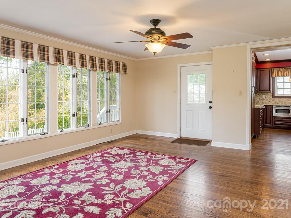 11 Hilltop Road Asheville, NC 28803 - Photo 19 of 42 a view of an empty room with window and wooden floor