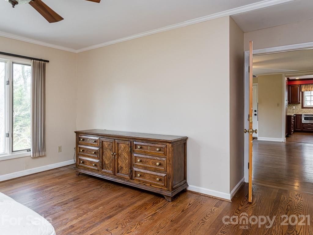 11 Hilltop Road Asheville, NC 28803 - Photo 21 of 42 a view of an empty room with window and wooden floor