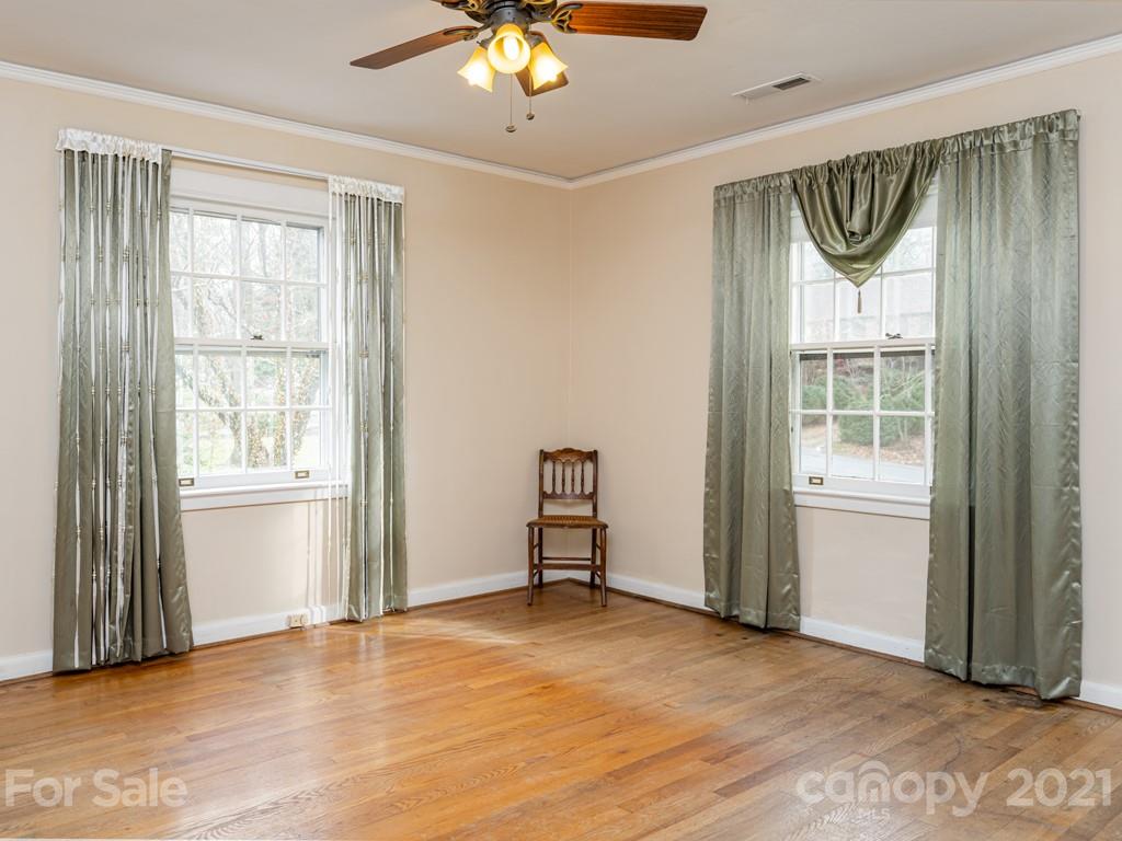 11 Hilltop Road Asheville, NC 28803 - Photo 30 of 42 an empty room with wooden floor and windows