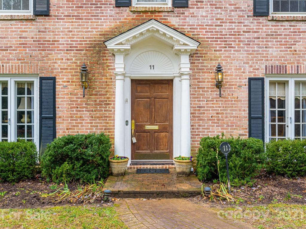 11 Hilltop Road Asheville, NC 28803 - Photo 4 of 42 a view of a brick house with plants and large windows