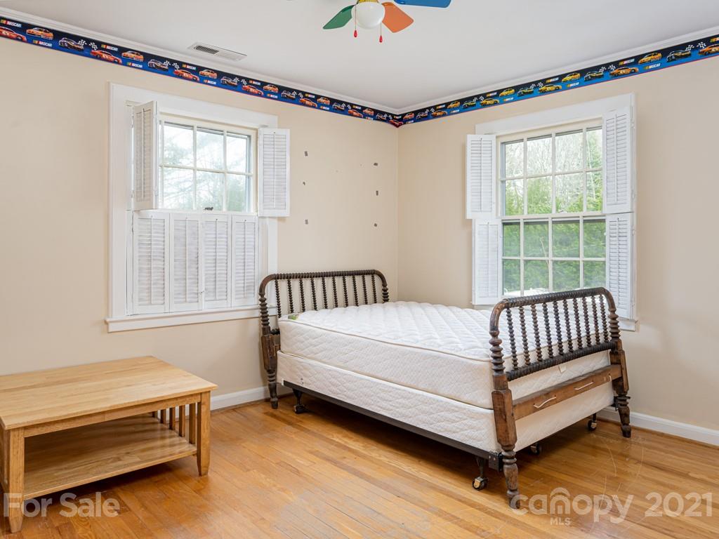 11 Hilltop Road Asheville, NC 28803 - Photo 31 of 42 a bed sitting in a bedroom next to a window