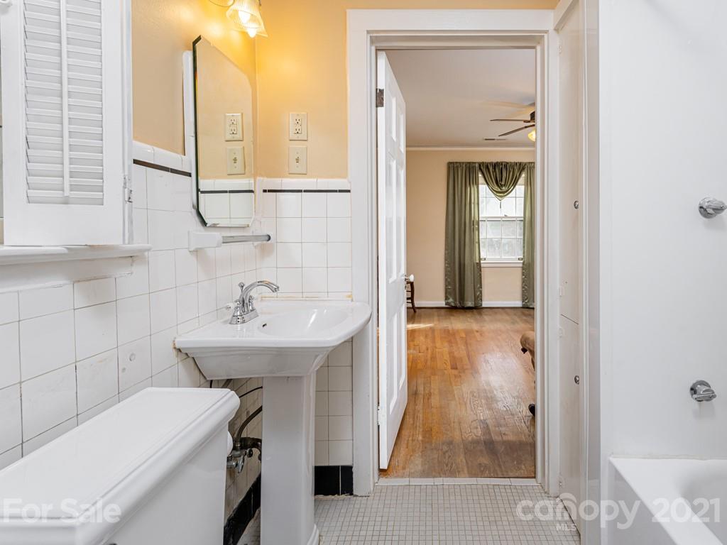 11 Hilltop Road Asheville, NC 28803 - Photo 32 of 42 a bathroom with a sink and a mirror