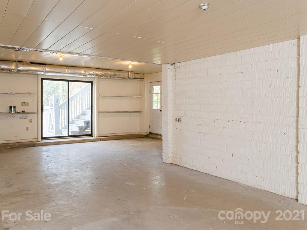 11 Hilltop Road Asheville, NC 28803 - Photo 33 of 42 an empty room with windows and cabinet