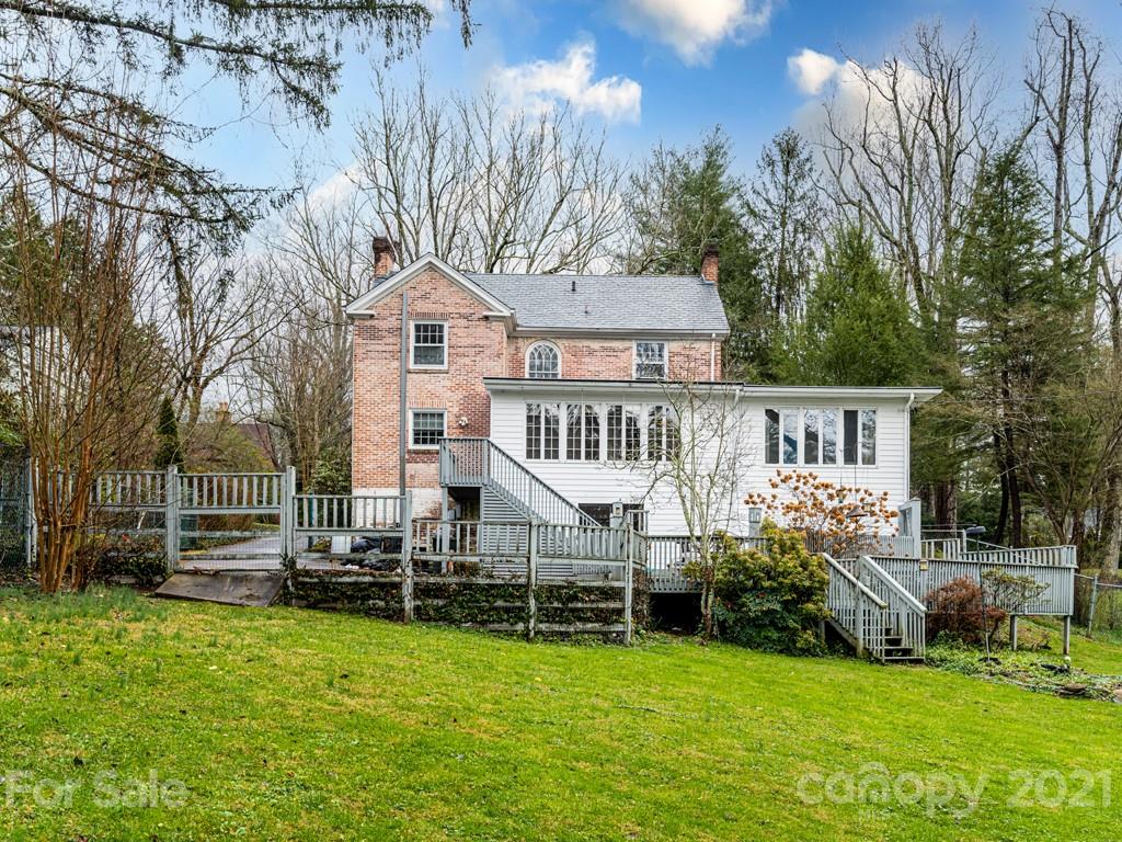 11 Hilltop Road Asheville, NC 28803 - Photo 40 of 42 a front view of a house with a yard table and chairs