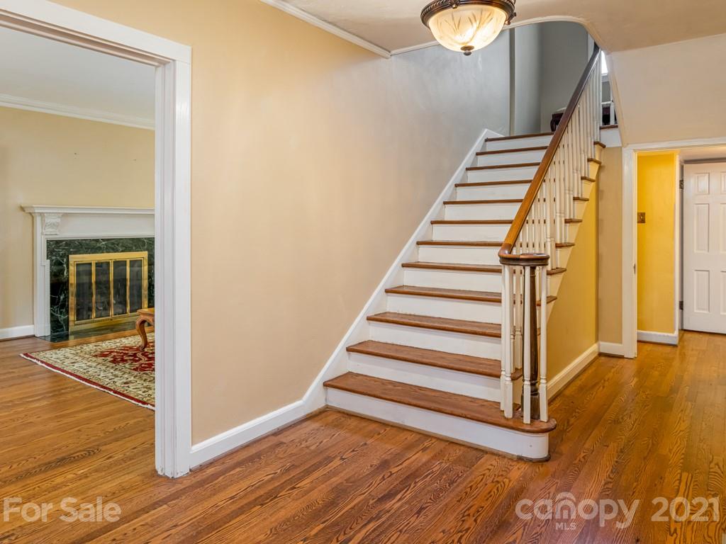11 Hilltop Road Asheville, NC 28803 - Photo 6 of 42 a view of a room with wooden floor and white walls