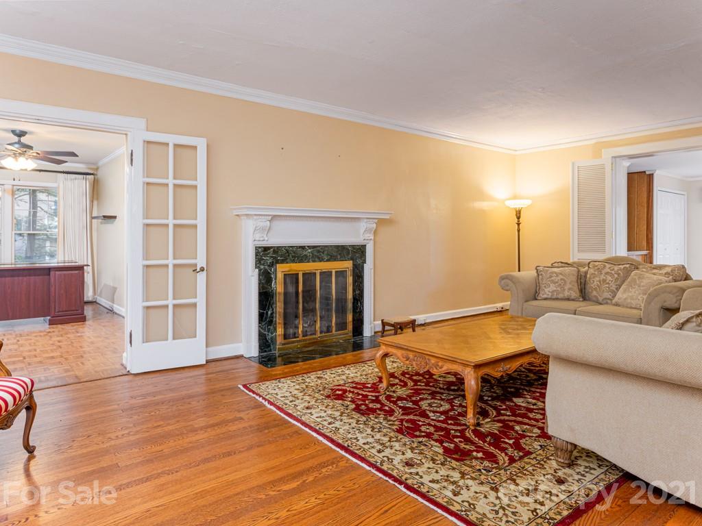 11 Hilltop Road Asheville, NC 28803 - Photo 7 of 42 a living room with a couch and a fireplace