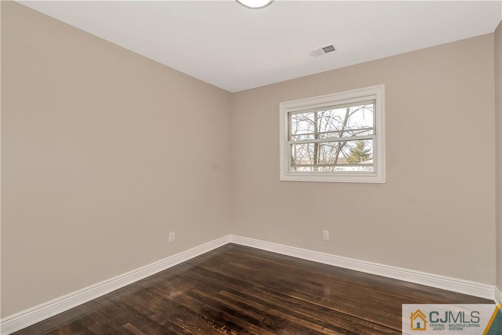 10 Jean Road East Brunswick, NJ 08816 - Photo 15 of 21 an empty room with wooden floor and windows