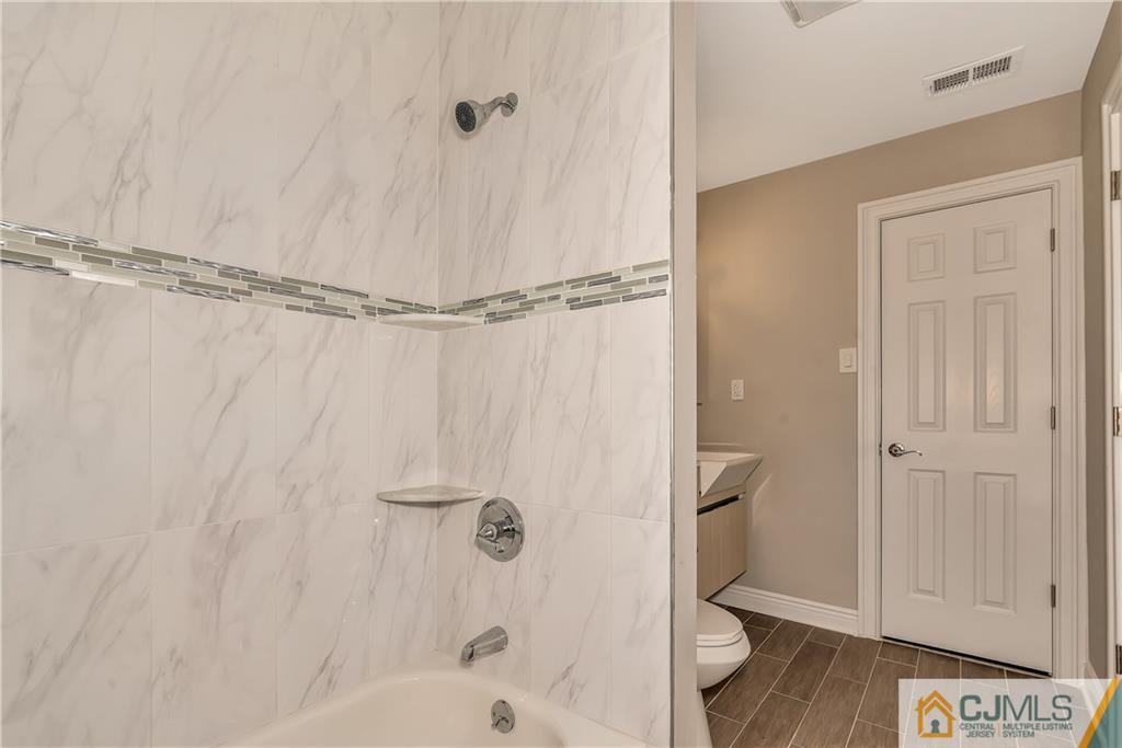 10 Jean Road East Brunswick, NJ 08816 - Photo 16 of 21 a bathroom with a bathtub and a shower