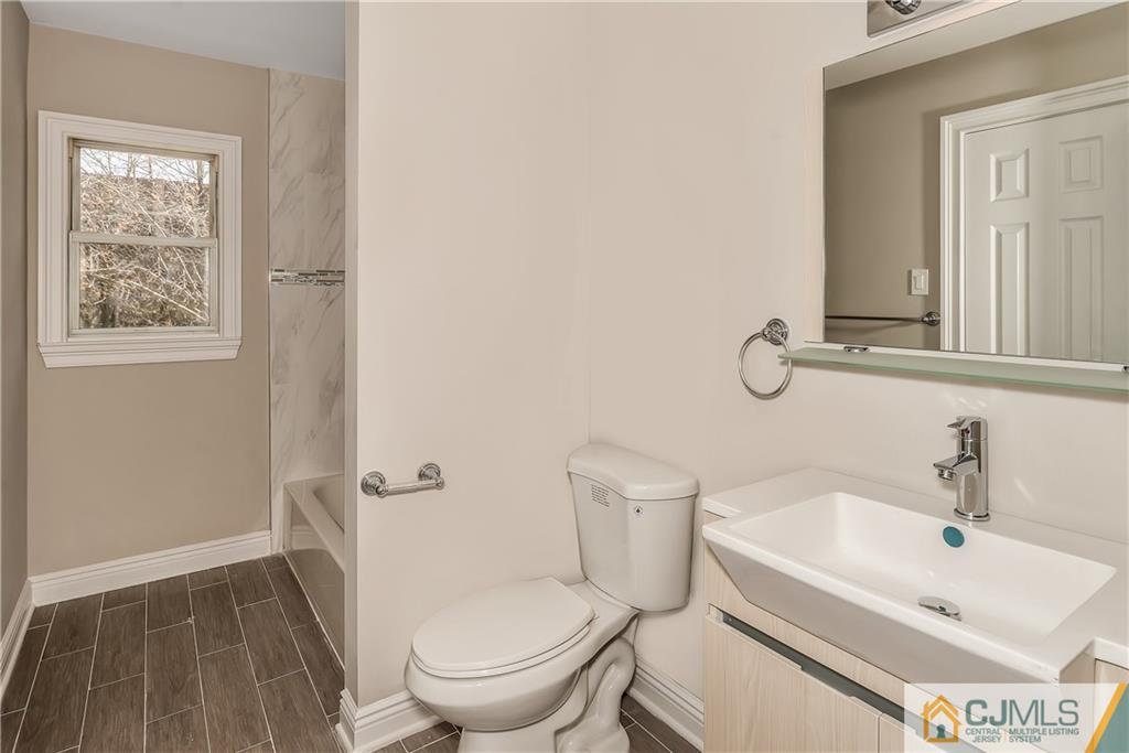 10 Jean Road East Brunswick, NJ 08816 - Photo 17 of 21 a white toilet sitting next to a bathroom sink