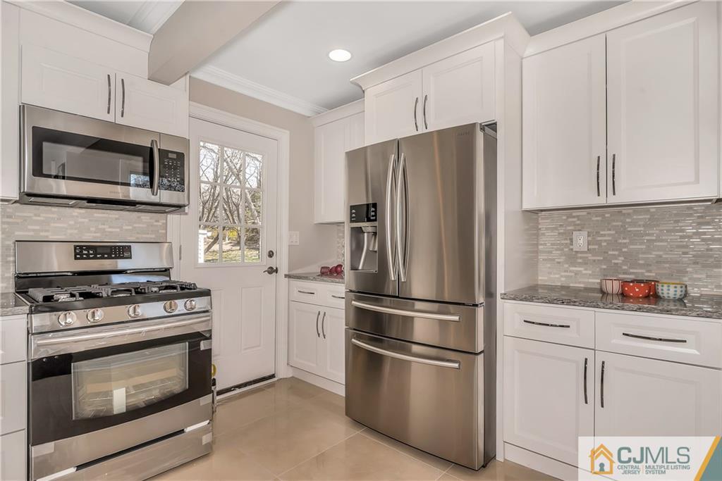 10 Jean Road East Brunswick, NJ 08816 - Photo 9 of 21 a kitchen with stainless steel appliances a refrigerator stove and microwave