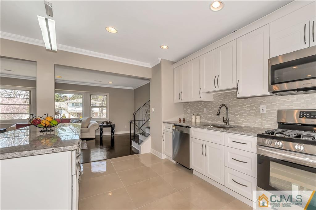 10 Jean Road East Brunswick, NJ 08816 - Photo 10 of 21 a kitchen with white cabinets a sink stove and refrigerator