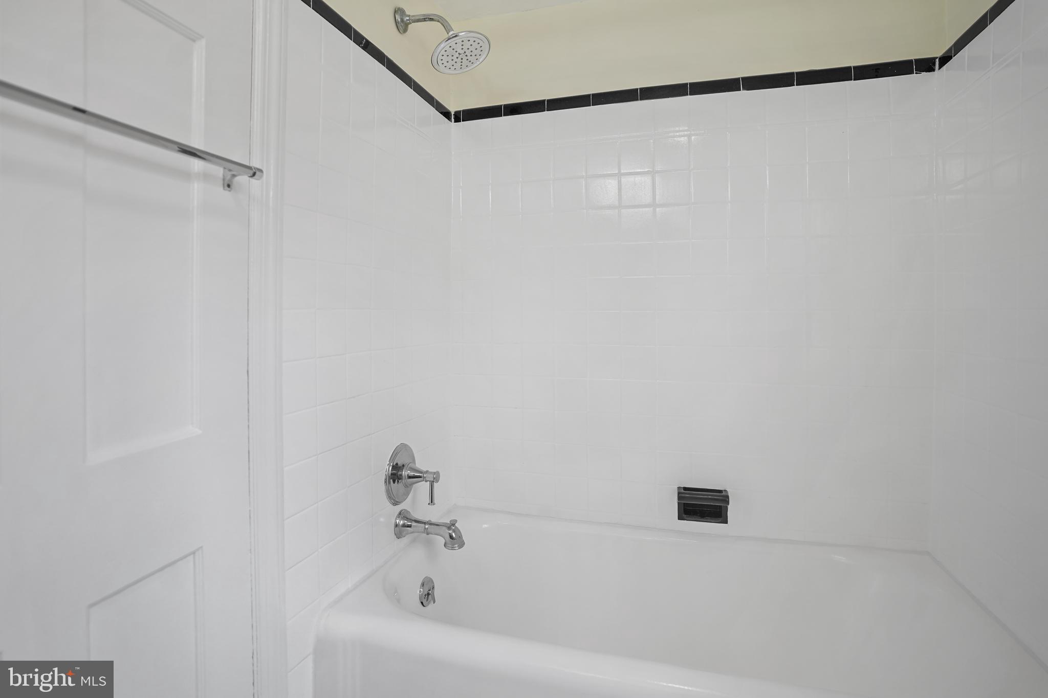 8907 Flower Avenue Silver Spring, MD 20901 - Photo 12 of 20 a white bath tub and a shower in a bathroom